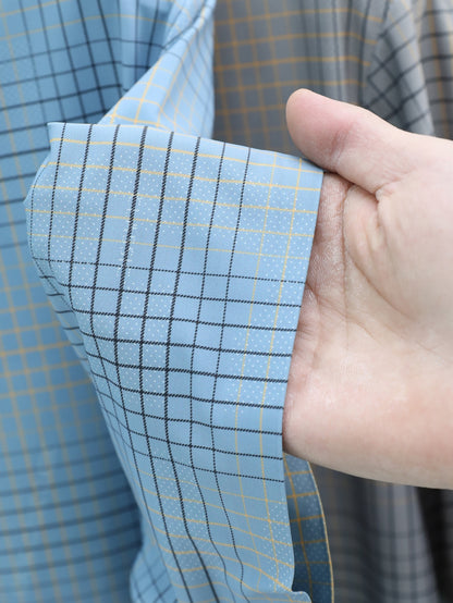 Jiskavi sky blue windowpane plaid stretch cotton fabric — dark navy grid and golden amber accent detail