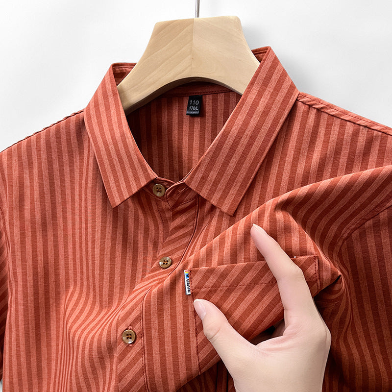 Close-up of terracotta rust pinstripe linen-feel shirt fabric and collar