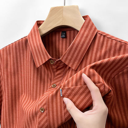 Close-up of terracotta rust pinstripe linen-feel shirt fabric and collar