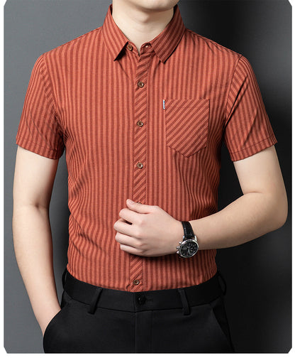 Model wearing Jiskavi terracotta rust striped short sleeve shirt with black trousers